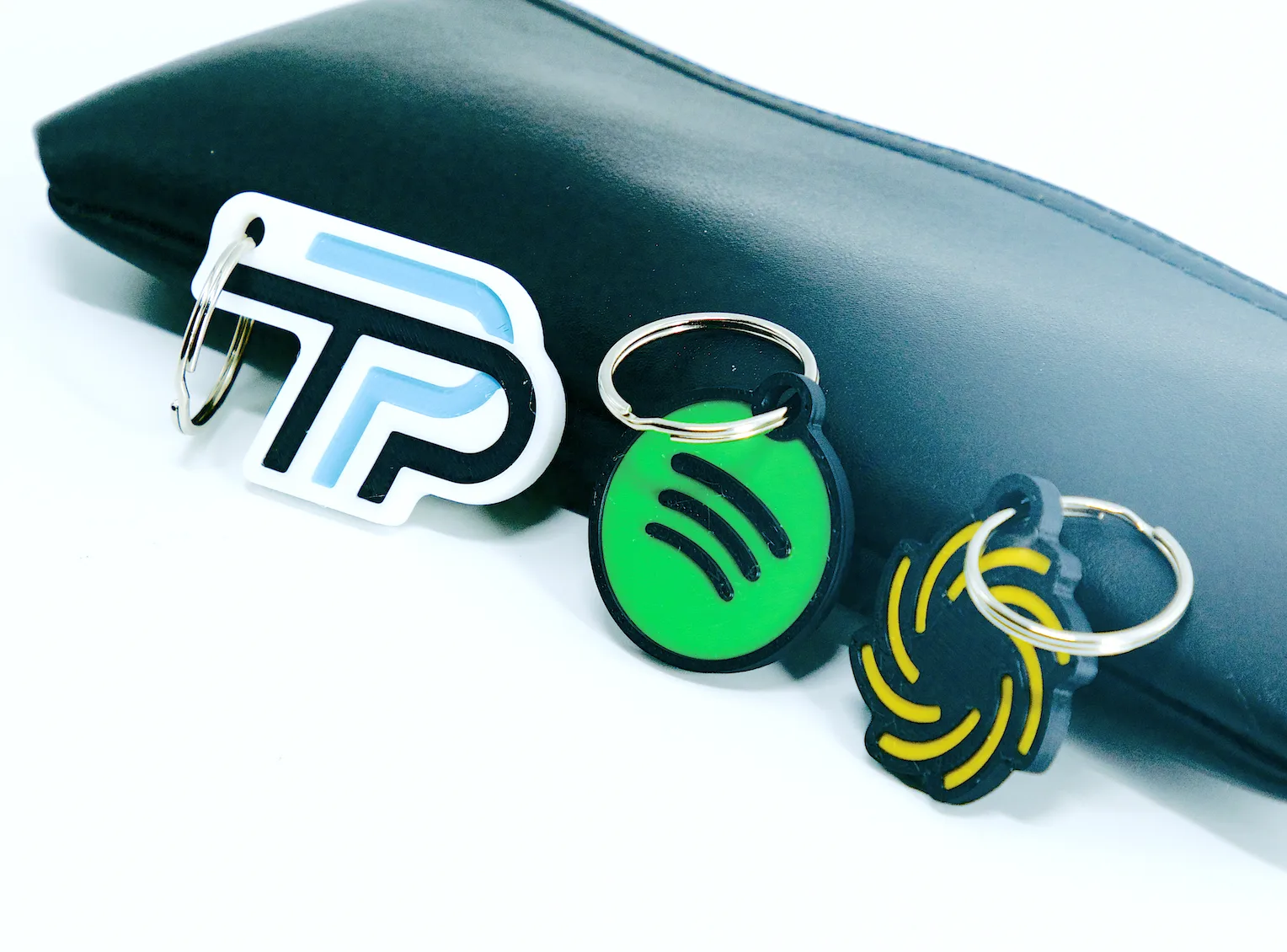 Collection of custom 3D-printed NFC keychains in various colors and designs
