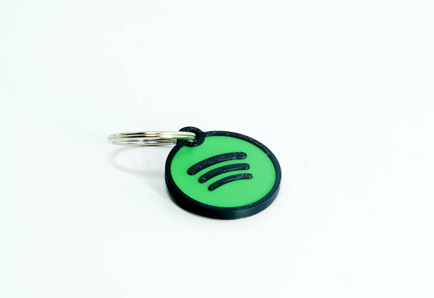 Custom NFC keychain with Spotify logo, links to a song or playlist on tap